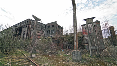 old industrial building for demolition. large ruined abandoned factory hangar or warehouse.