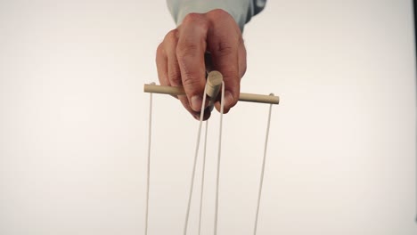 Hand Holding Puppet Strings