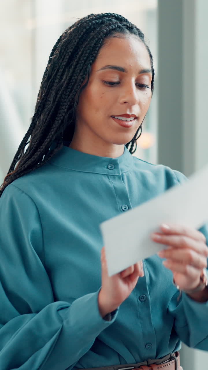 Professional Woman Opening an Envelope with Paper Inside