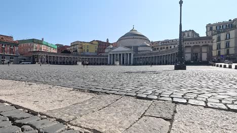 cobblestone square with historic buildings and dome