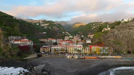 waves roll onto shore by the small town of ponto do sol, madeira