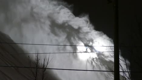 snow powder being splashed and piled up, against light background, at night