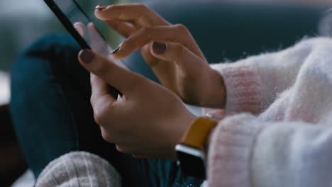 close up woman hands using tablet computer browsing social media checking emails on mobile touchscreen device relaxing at home