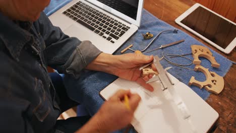 female luthier at work in her workshop