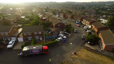 aerial view, footage of dustmen putting recycling waste into a garbage truck, bin men, refuse collectors