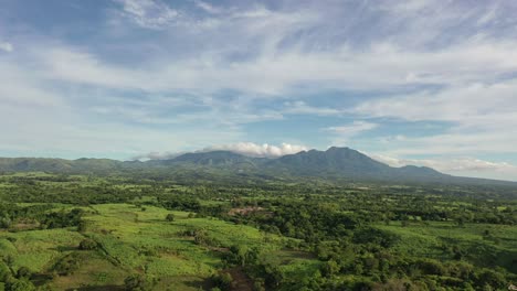 Aerial-view-of-a-landscape-in-Negros-Oriental,-Philippines,-with-mountains-and-clouds