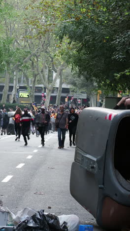 barcelona - spain - october 18 2019 : riot police clash with protestors at the general strike in via laietana, barcelona in vertical