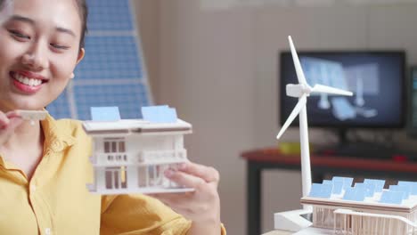 woman examining a sustainable energy model home