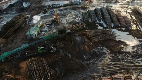 Drone-view-of-logging-equipment-in-Canadian-winter-landscape