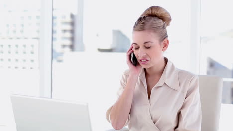 content blonde businesswoman phoning