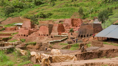 medium wide shot of brick making operation in rural rwanda