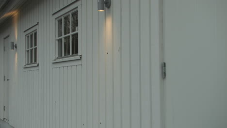 man enters garage, exterior shot
