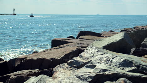 boat drifts into new jersey harbor over bright rigid stones