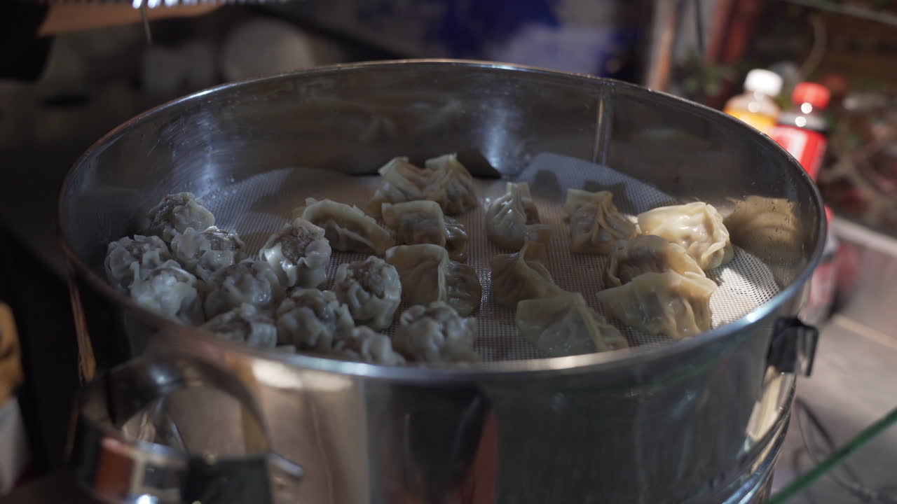 Food Vendor Covers Siomai And Dumplings In A Steamer With Stainless Steel Lid