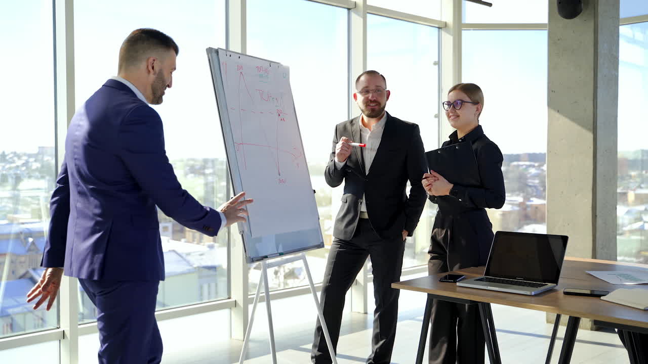 Entrepreneurs work and joke in office centre. Positive business coworkers talking happily in modern office in the city.