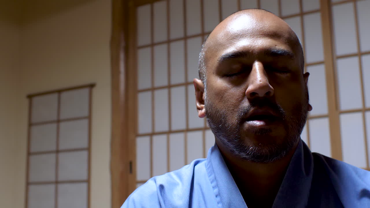 Asian Indian Bald Male Man doing Zazen, a meditative discipline that is typically the primary practice of the Zen Buddhist tradition