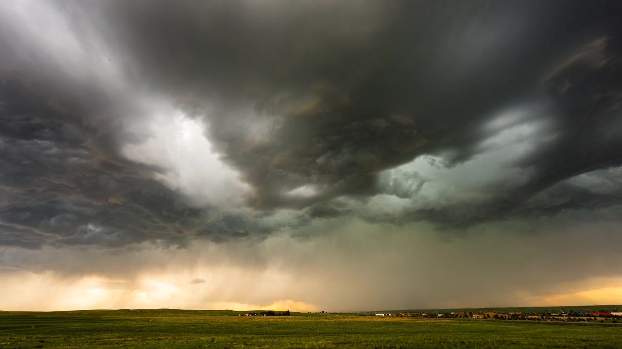 Menacing storm front moving over landscape with dark cloud layers
