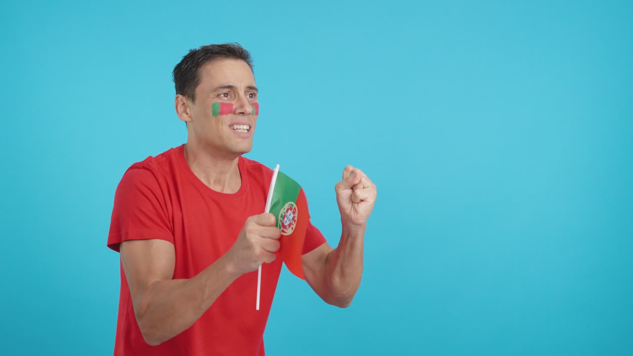 Nervous man cheering for Portugal during a match looking away
