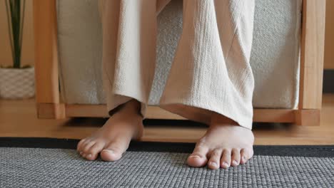 barefoot woman sitting on a chair