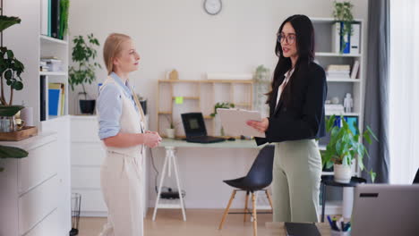 Two-Businesswomen-Greet-Each-Other-and-Smile