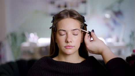 woman getting eyebrow makeup at a beauty salon