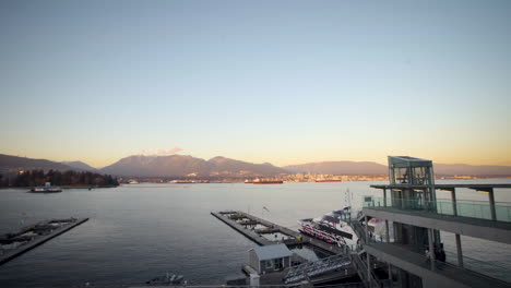 Wunderschöne-Berge-Gegenüber-Einer-Uferpromenade-Und-Einem-Hafen