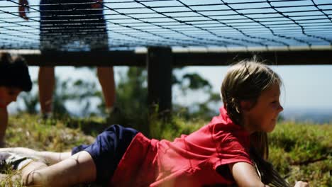 Kids-crawling-under-the-net-during-obstacle-course-training