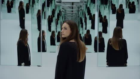 woman in a mirrored room with infinite reflections