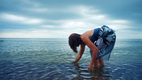 female tourist on calm and pristine beach in karkle, lithuania