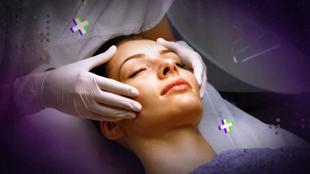 Clinician cupping and rubbing client's face for skin care, lamp lighting, purple overlays appearing