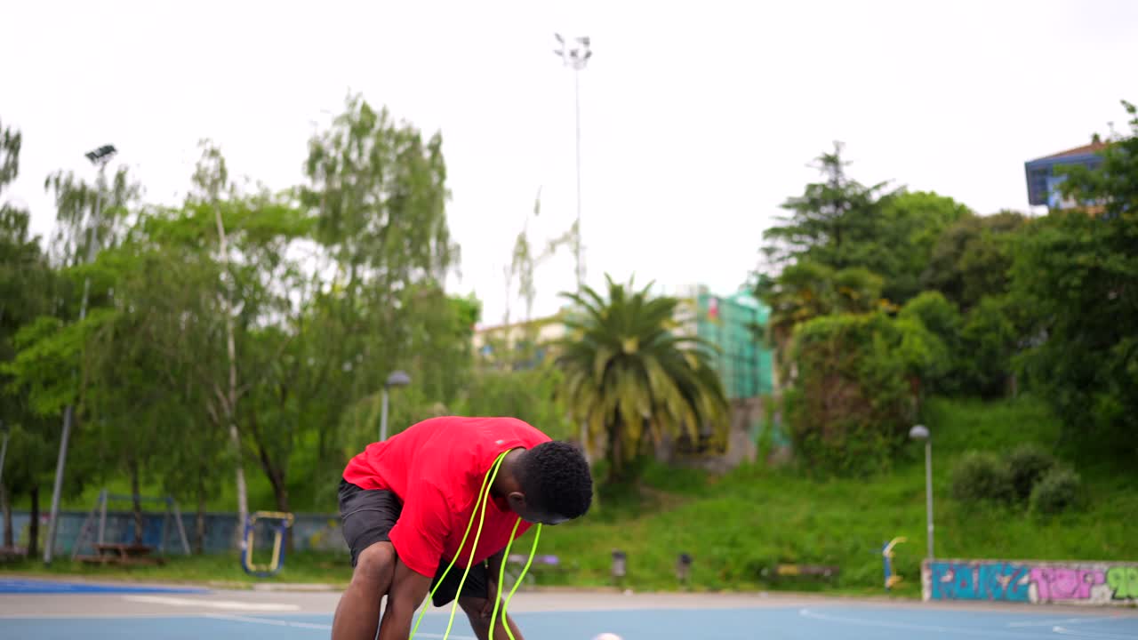 A man exercising on a basketball court