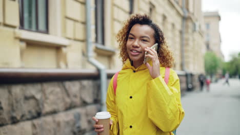 young woman walking and talking on phone