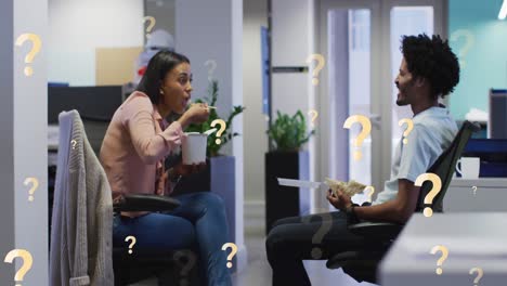 Animation-of-question-marks-over-african-american-coworkers-talking-while-having-food-at-office