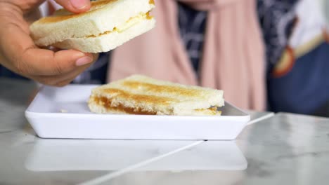 a person eating kaya toast