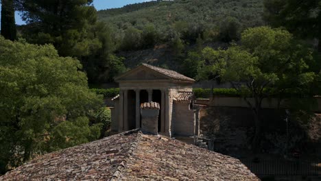 Aerial-View-Of-Temple-of-Clitumnus,-Flying-Over-Roof-Tiles-And-Chimney