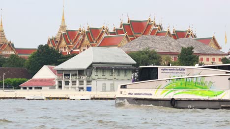 a boat travels past a historic temple