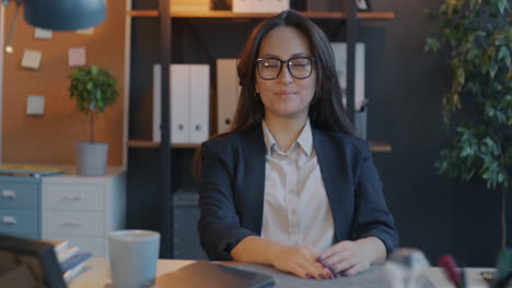 woman in business attire at office desk