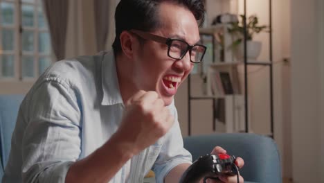 excited overjoyed male winner a game, hand gesture, celebrating success, sitting at home