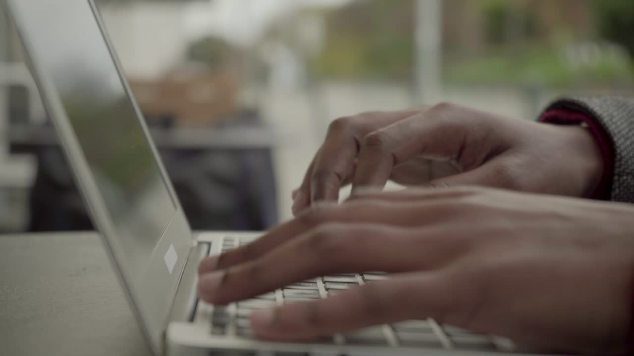 Cropped shot of man working with laptop computer