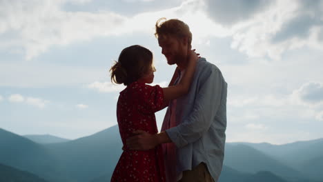 lovely marriage hugging on mountain slope summer. happy couple dancing outdoor.