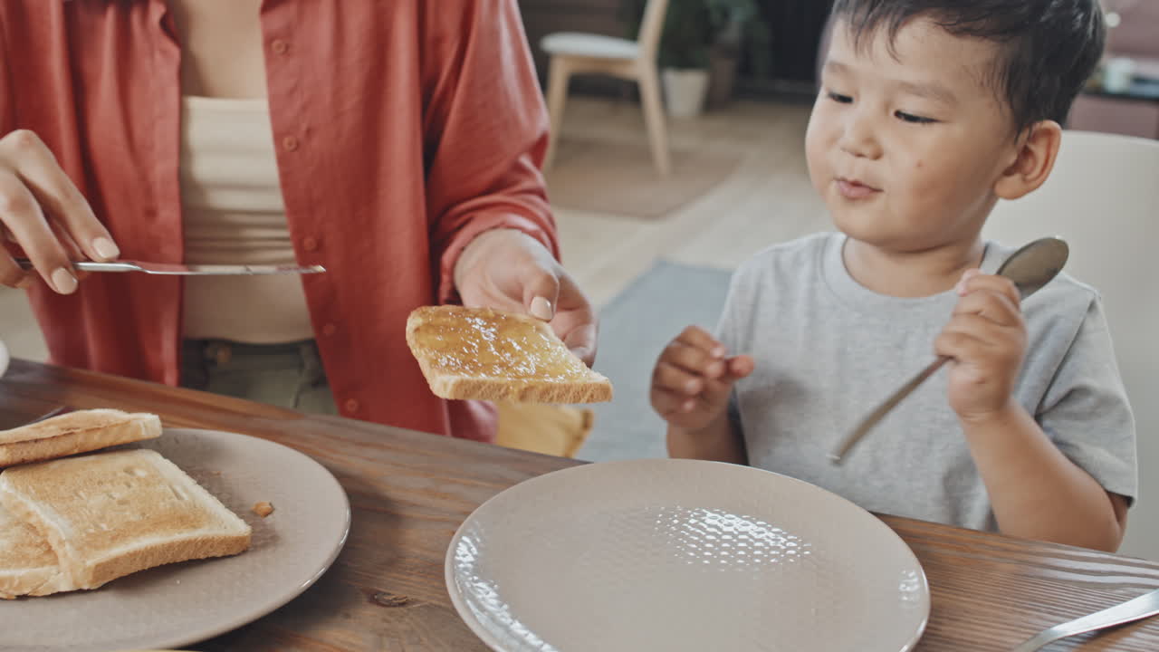 Asian Boy Having Breakfast with Mom at Home