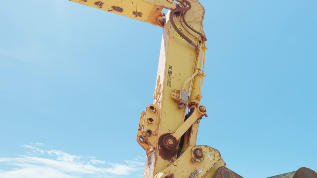 Detail clips of a construction excavator at the beach. Clip 6