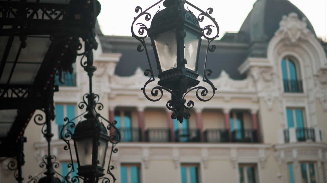 Close up of a street lamp with a blurry building view in Monaco