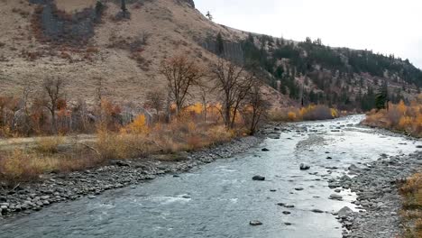 ariel drone footage of a rugged river valley in fall