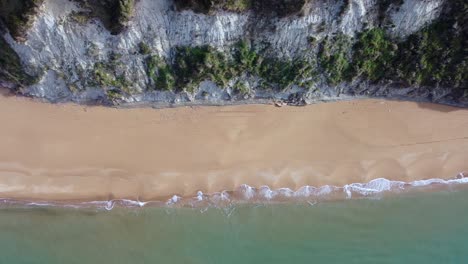 great aerial view flight slider fly sideways from right to left drone footage of the coastline and waves at paradise nature canyon dream beach corfu greece