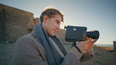 camera man filming sunset nature closeup. happy photographer enjoying hobby