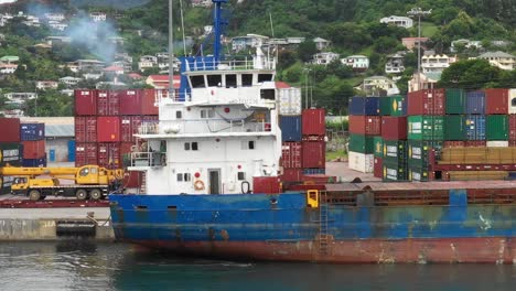 flying alongside stacked shipping containers