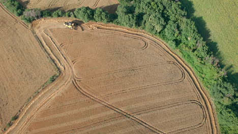 Drone-Shot-with-Top-View-of-Mowing-Machine,-Harvesting-on-Yellow-Wheat-Field-for-Agriculture