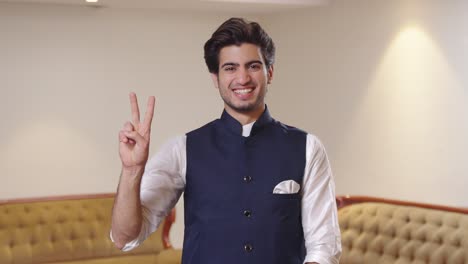 indian politician showing victory sign to the camera