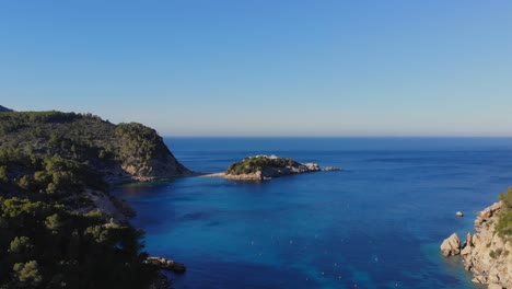 drone rising by a bay on ibiza